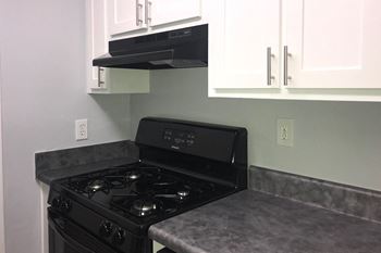 Renovated kitchen showing white cabinets and faux granite countertops at Laurel Springs, North Carolina, 27609